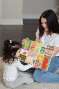 Rebecca reading a picture book with a young child