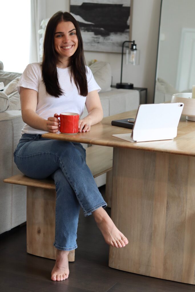 Rebecca Gilligan, speech-language pathologist, seated at a table with a mug